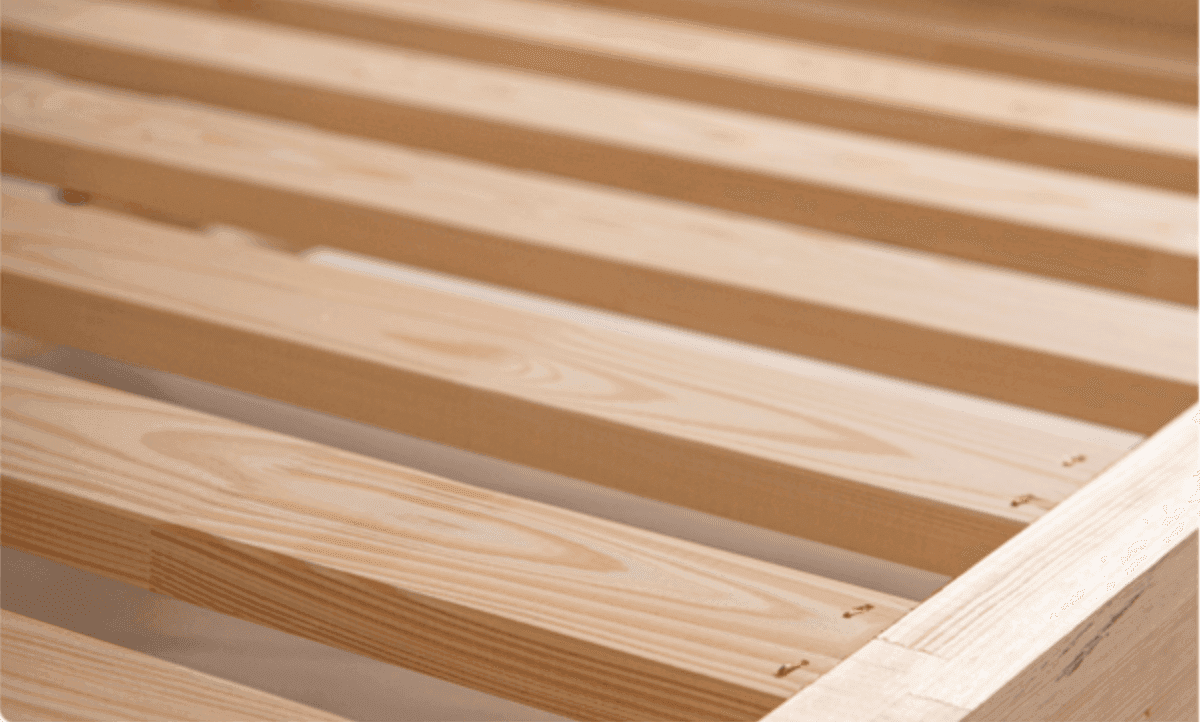 Close-up of the bed frame slats and solid wood edge