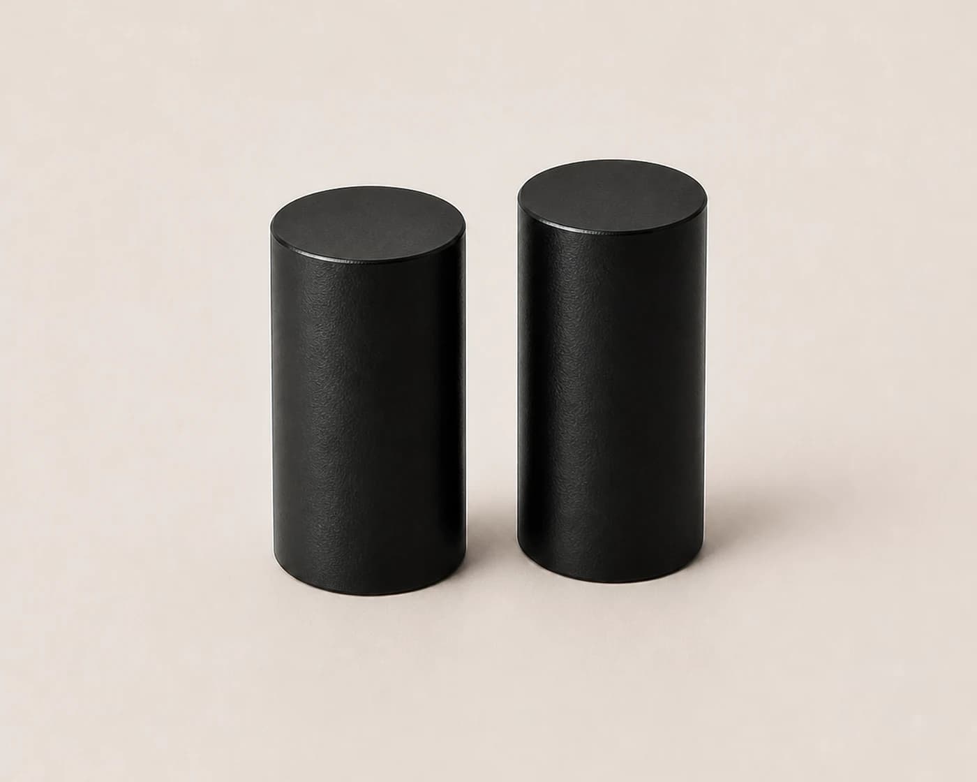 Two black cylindrical centre legs on a light surface