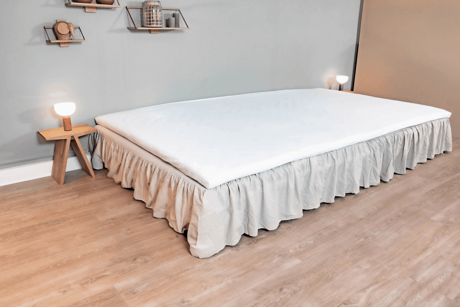 Beige FAMBED® bed skirt along the side of the bed