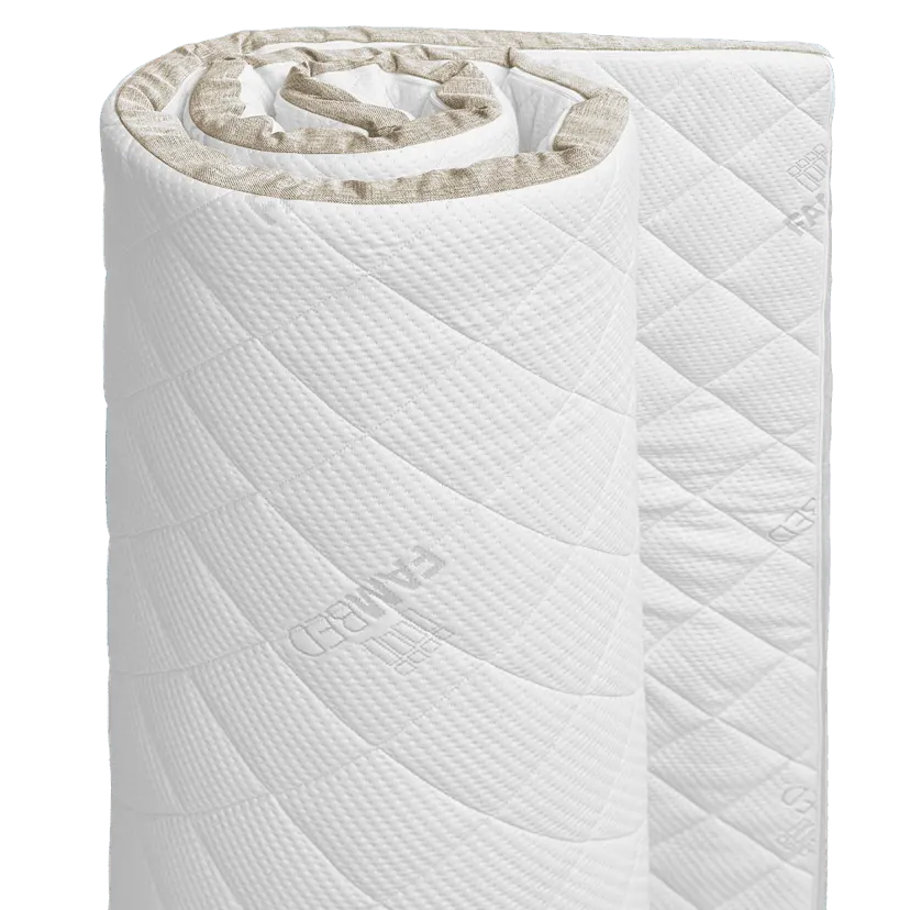FAMBED mattress topper rolled up, with a quilted white cover and beige piping